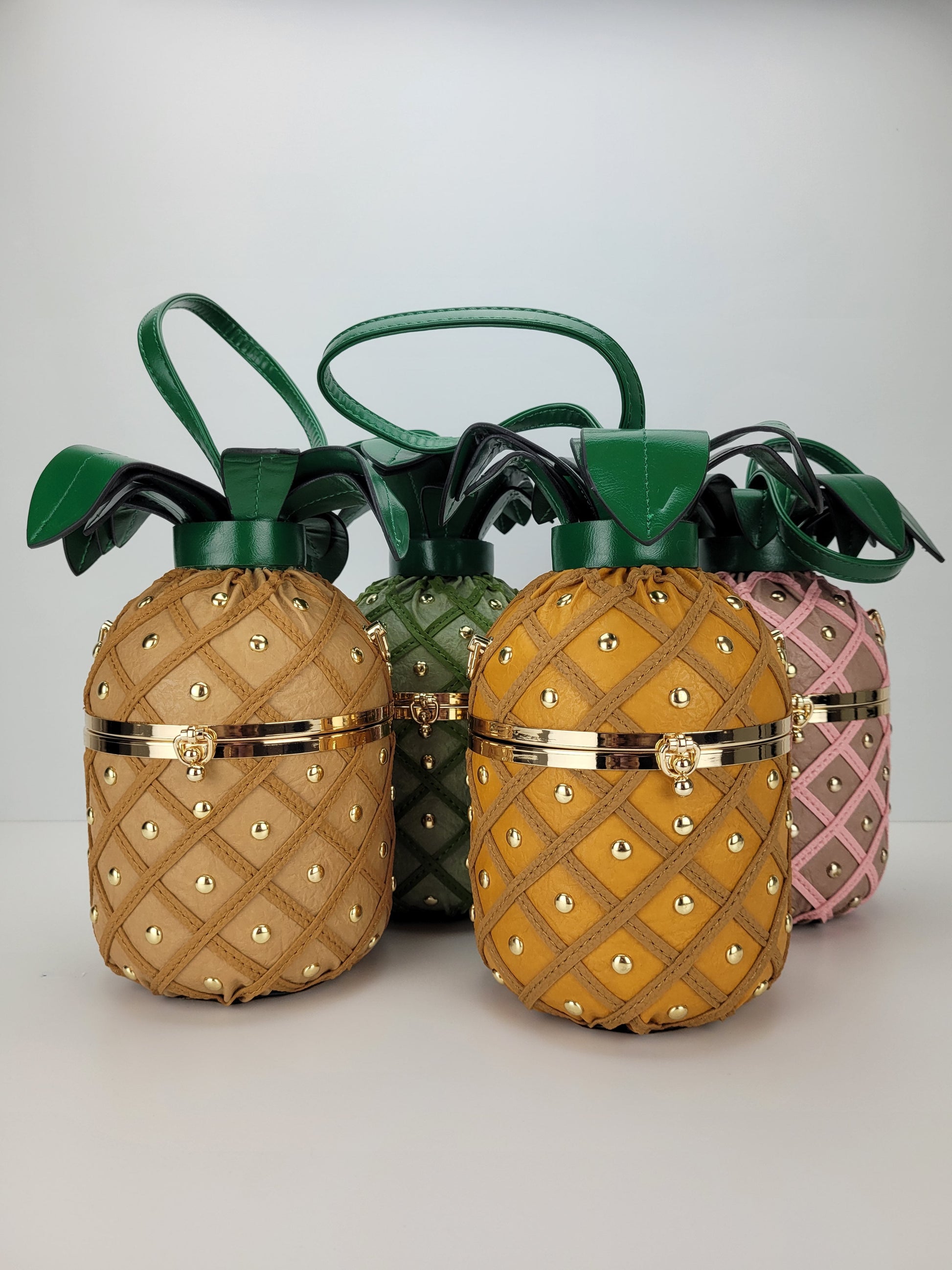 green, tan, yellow and pink pineapple handbags