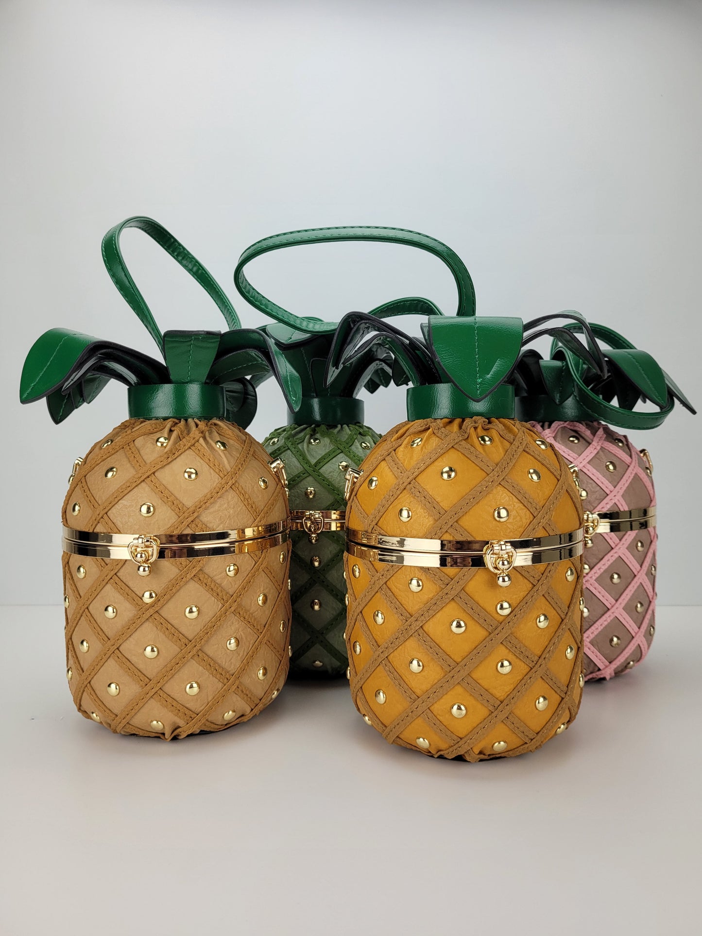 tan, green, yellow and pink pineapple handbags