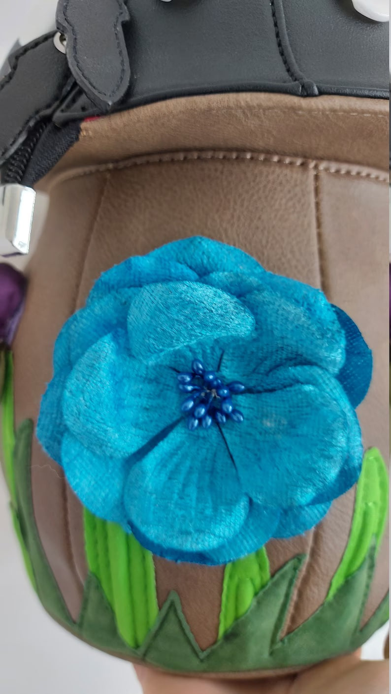 blue flower on black mushroom bag